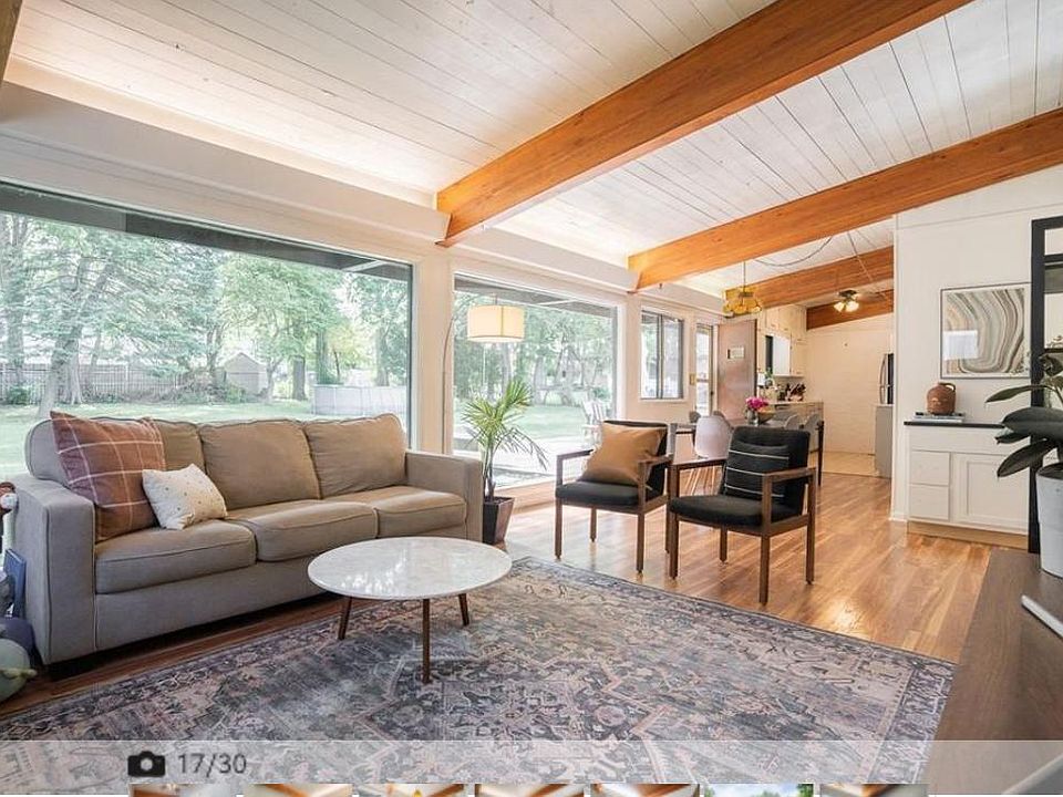 living room area leading to dining and kitchen areas