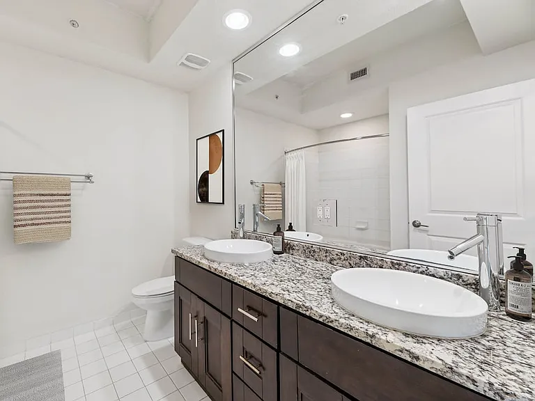 Classic Package bath with granite countertop (in most homes) and oak cabinetry