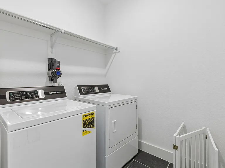 First floor laundry room with Speed Queen washer and dryer.