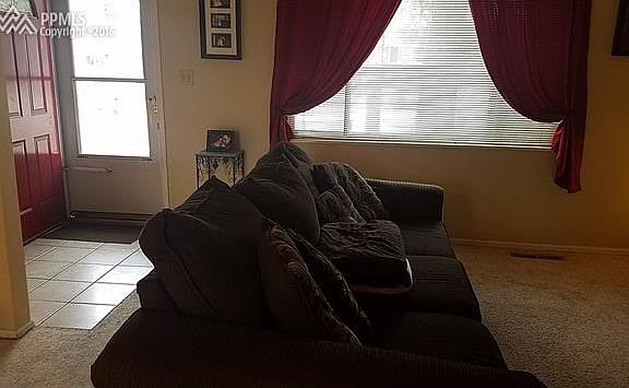 Enter into the living room from front door.