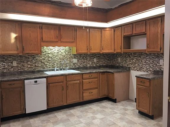 Kitchen features new sink, counter-tops, backsplash & flooring!