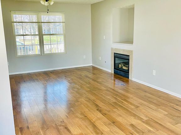 Living room with fan and gas fireplace
