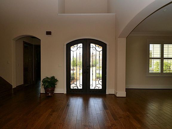 Entry offering double glass front doors with wrought iron ra
