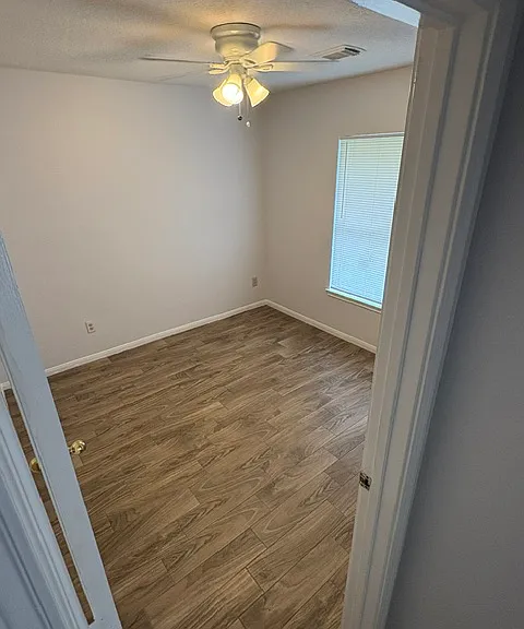 corner bedroom - tiled floors, ceiling fan