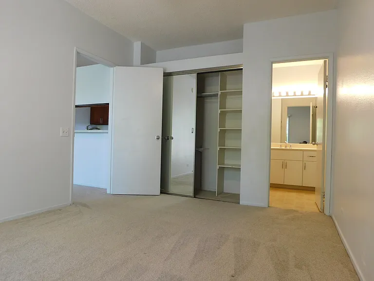 Bedroom #2. Mirrored closet doors. Toward bathroom #2