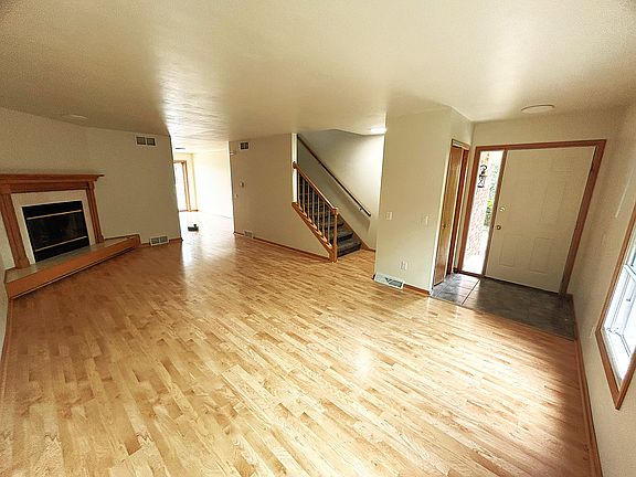 Front door with adjacent coat closet leading into the living area
