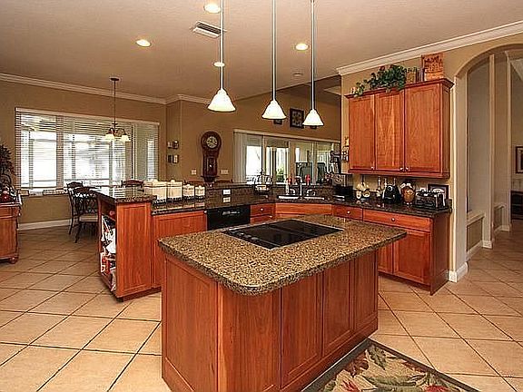 Delight in your Gourmet Kitchen w/ walls of cabinetry, granite & wine cooler