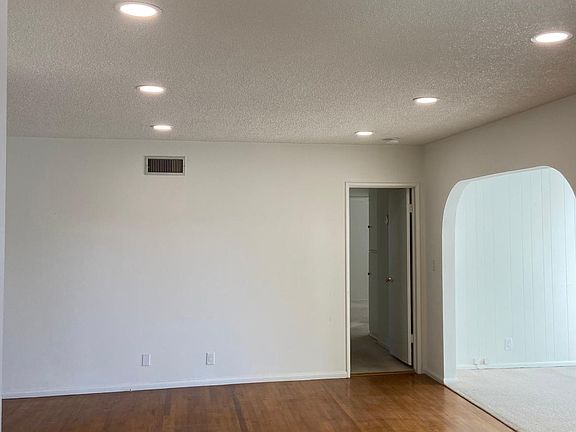 Living room with original hardwood floors and new recessed lighting