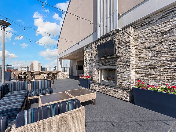 SkyDeck seating and fireplace with stunning city views