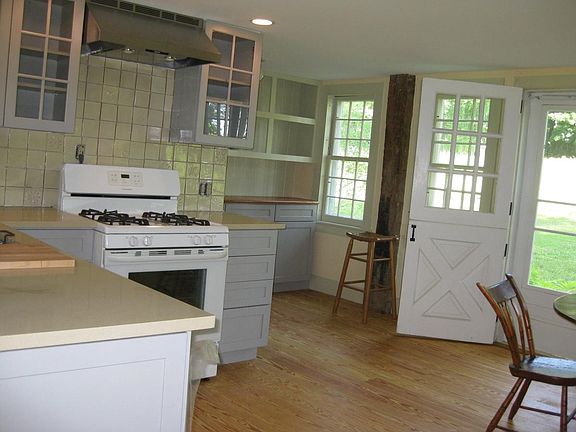Open kitchen with north and south facing windows and doors
