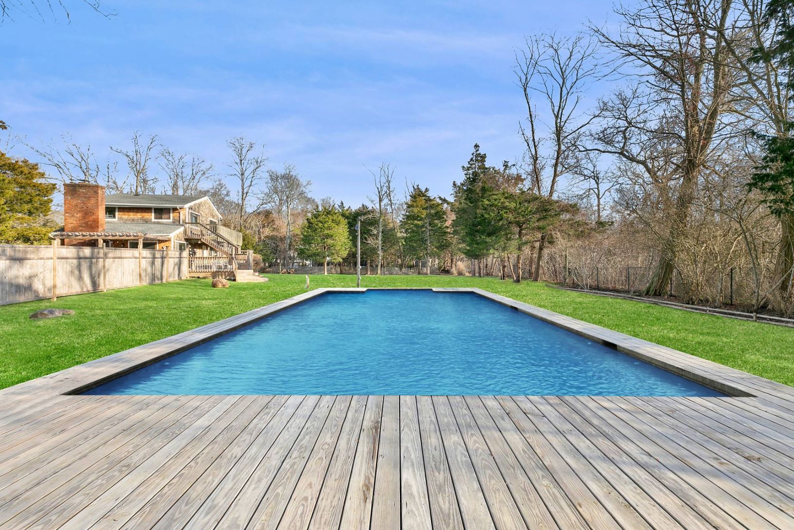  20x40 Heated Pool. Furnished with loungers, Adirondack chairs, tables and umbrellas