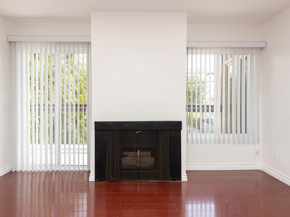 Living Room Facing Balcony and Fireplace