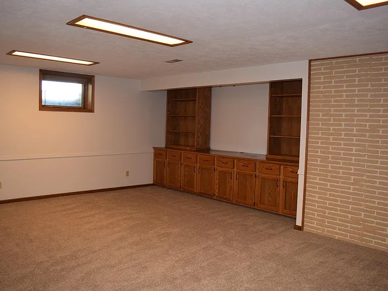 basement living room with built in entertainment center