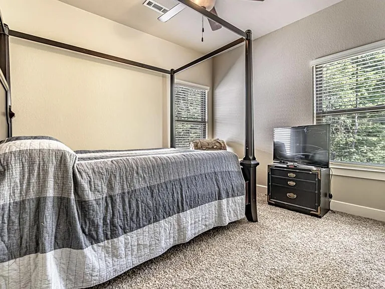 Bedroom in back and on left side of house. This bedroom has a walk-in closet and is closes to shared bathroom.