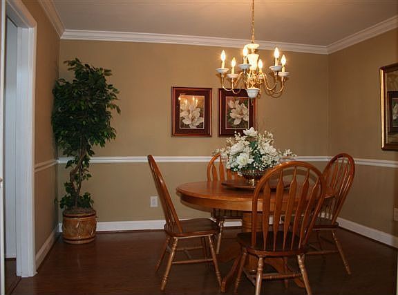 Separate dining area with chair rail and crown moulding