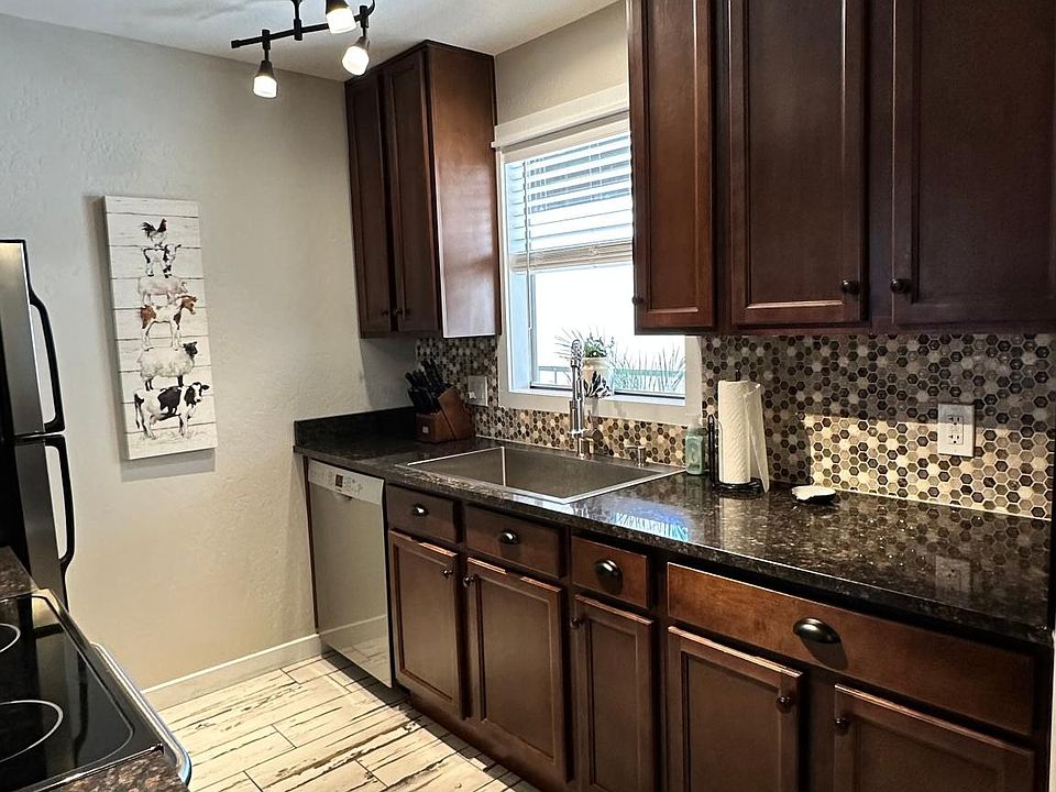 Beautiful updated and renovated kitchen with tile backsplash and new lights.