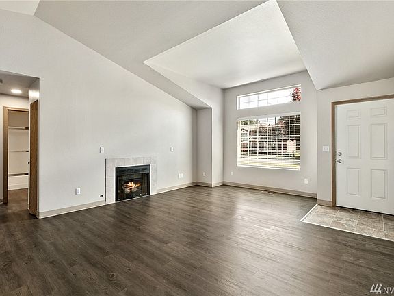 The entry foyers open directly into the luminous vaulted living room. 