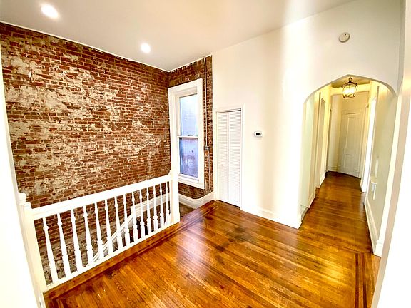 Entry landing looking down the hallway towards bathroom, kitchen and second bedroom.