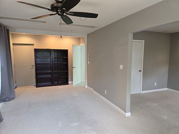 Living room space with adjoining bedroom and door to hallway 23 ft x 10.2 ft.