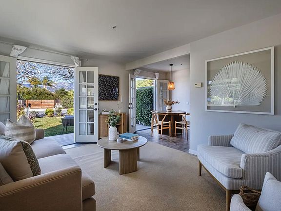 Spacious living room with french doors that open to the and landscaped front yard.
