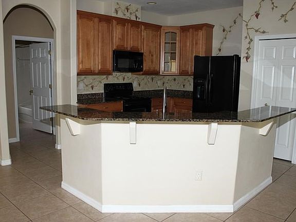 Kitchen with Granite Breakfast Bar and Closet Pantry