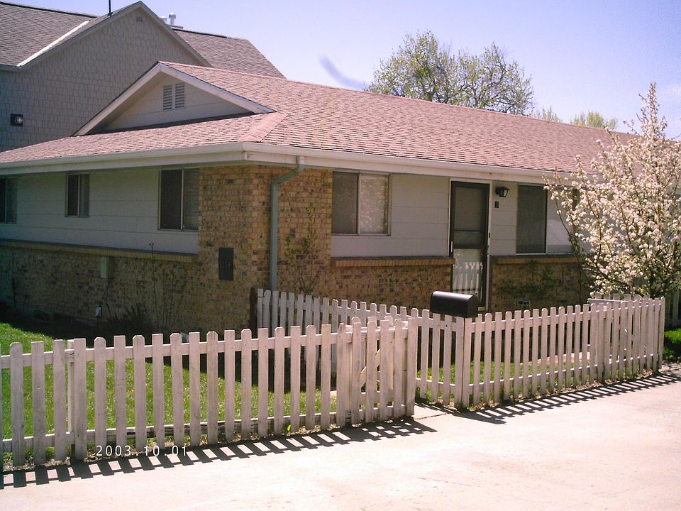 front door to unit with private yard and adjoining side yard