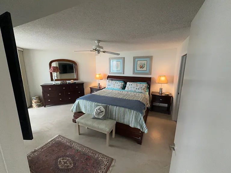 Master Bedroom, king bed. TV on wall.
