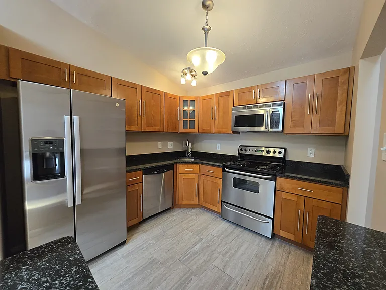 Beautiful upgraded kitchen with full sized stainless steel appliances