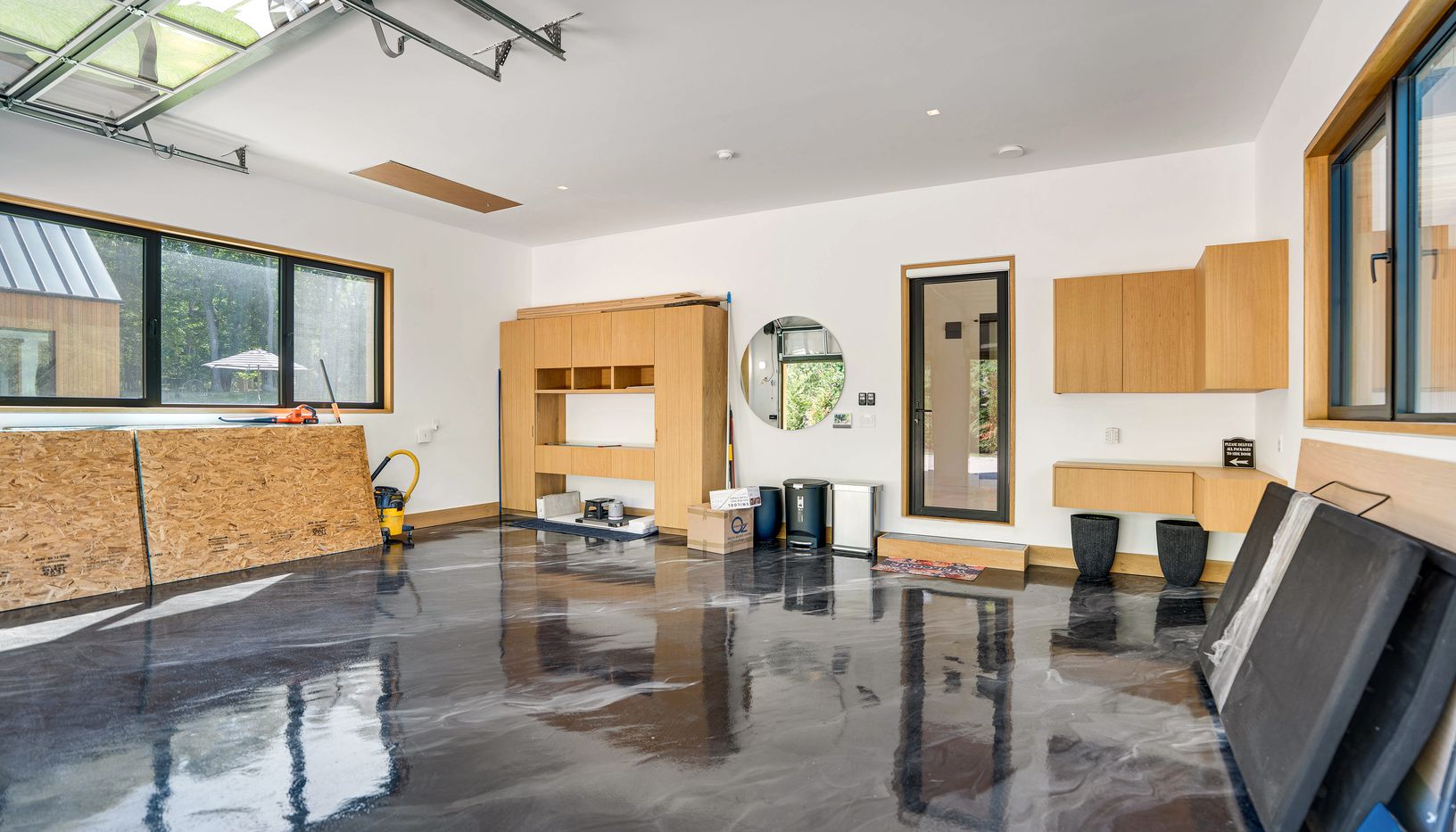  2 car garage with marble epoxy floors and white oak built ins throughout 