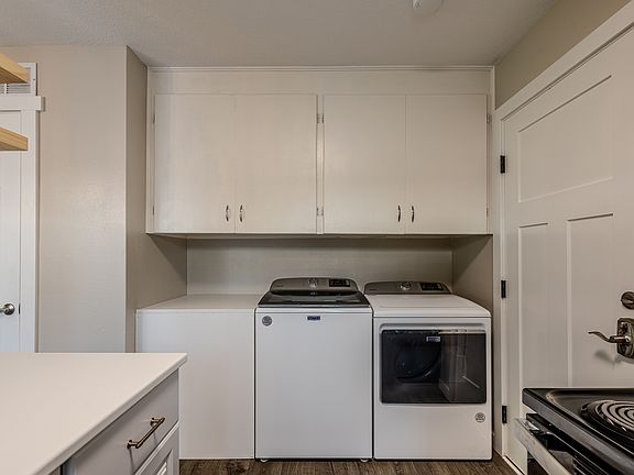 The laundry area includes a folding countertop.