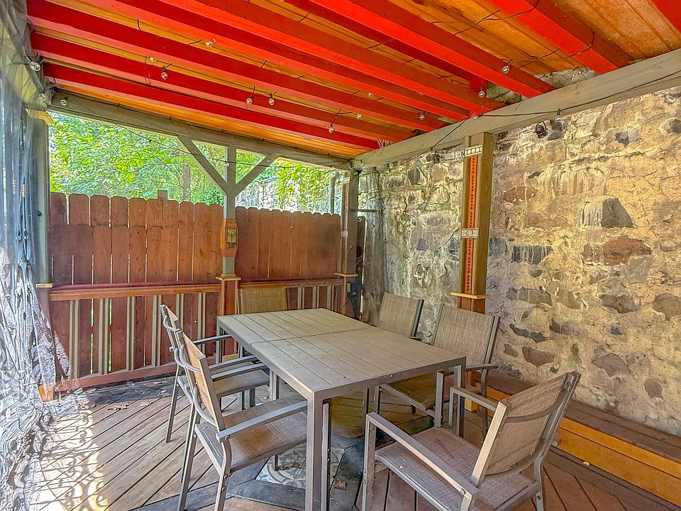 Dine or unwind under the wrought iron-framed pavilion in your secluded backyard oasis.