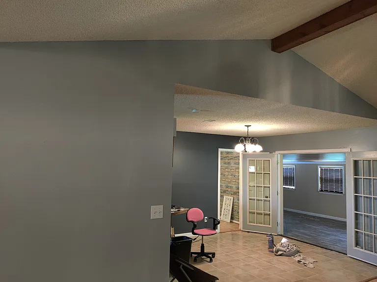 from front door view of dinning room, office and french doors leading to sunroom which has multiple windows, tile floors that look like wood planks and a door that leads to the deck, fenced backyard and also leads to the gameroom/mother in law suit..