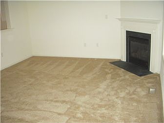 Living room with new carpet and gas frieplace