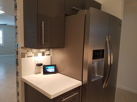 Functional kitchen has in and out entrances for preparing meals without exposing the kitchen mess to the living room.