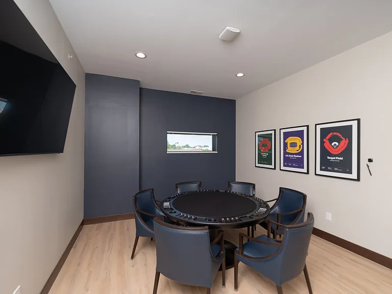 A shared game table with seating and wall-mounted TV for casual entertainment.