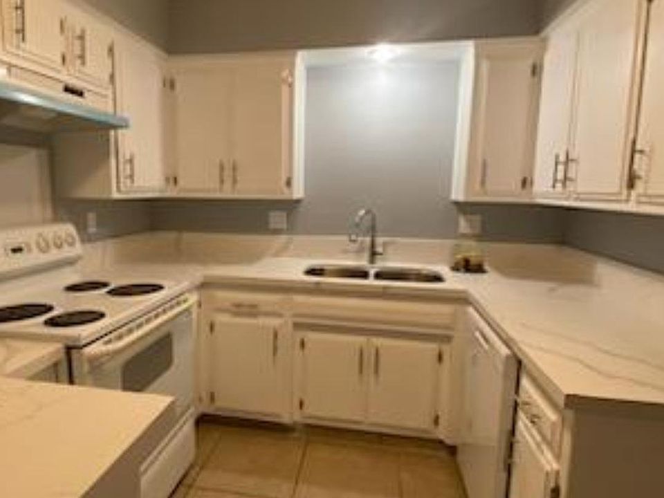 Kitchen with dishwasher and stove provided.