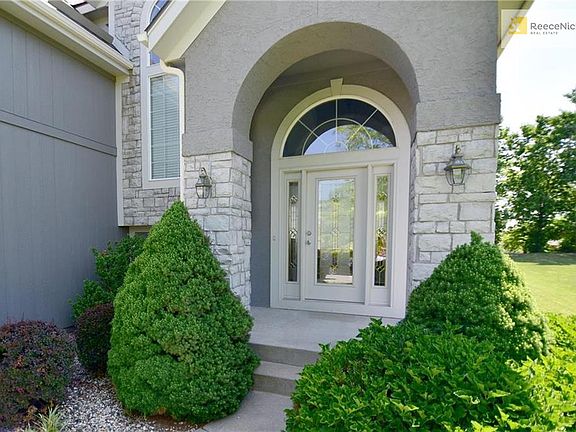 Builder-expanded two-story with dramatic entry