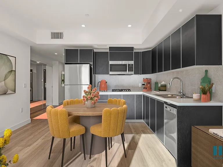 Open-Concept Kitchen with Stainless-Steel Refrigerator, Dishwasher, Range Stove, and Microwave Oven - Sycamore Floor Plan