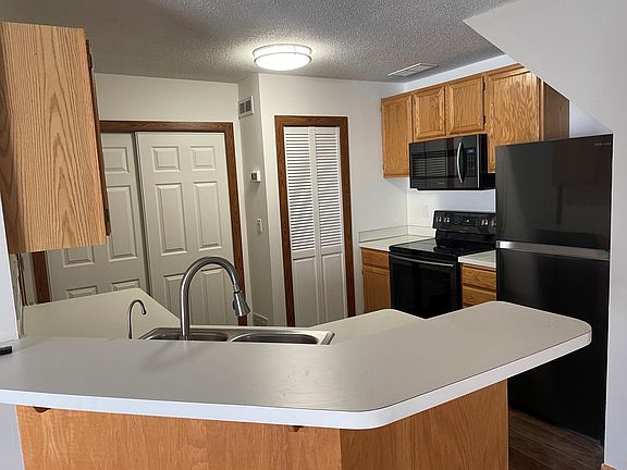 Kitchen with new stainless steel appliances.