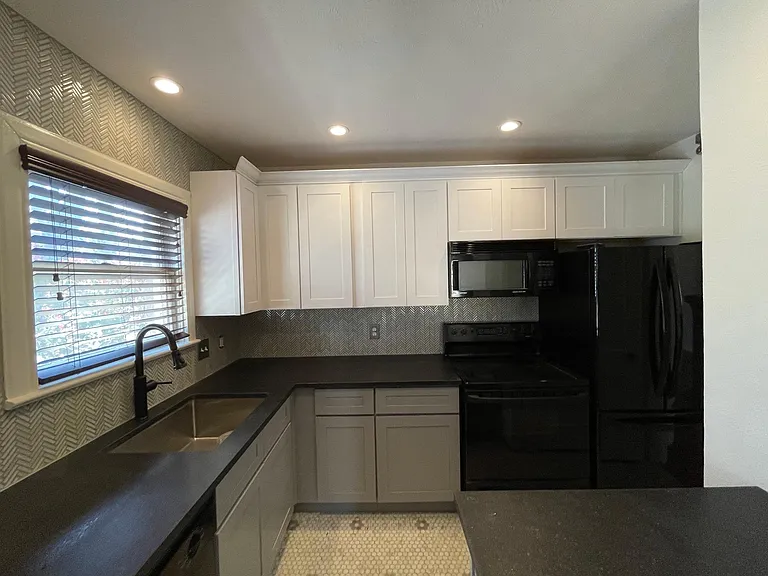 Kitchen with Dishwasher, Microwave, Stove and Fridge.