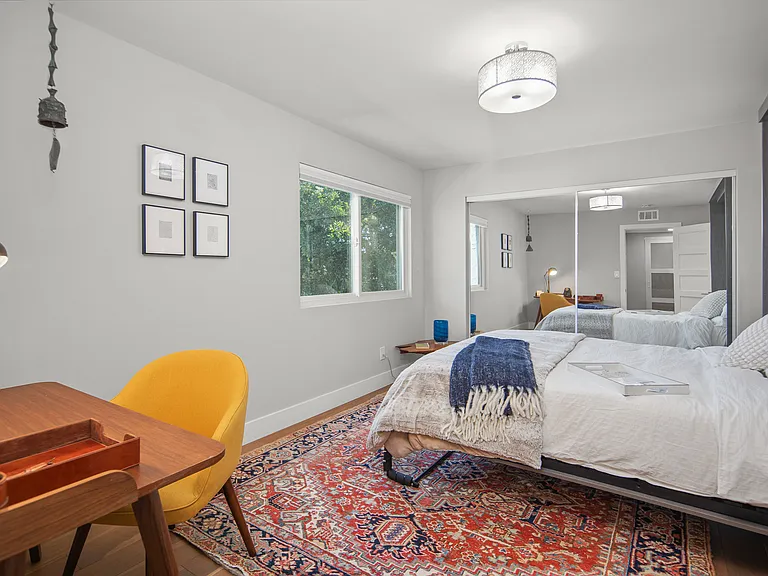 Bedroom with queen Murphy bed and desk area.