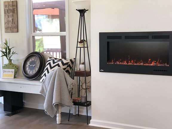 Sitting bench in living area, next to fireplace and looks ou