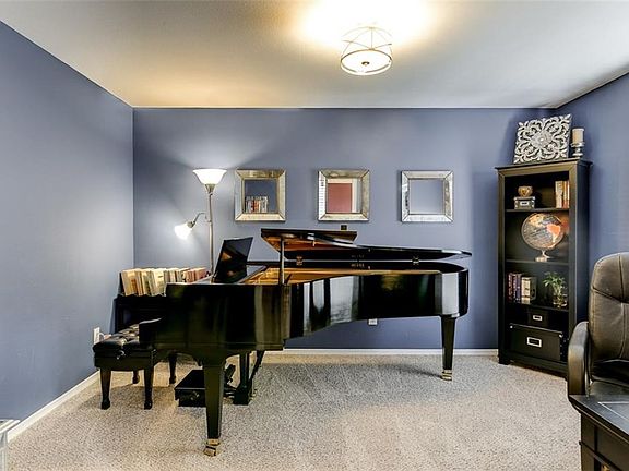 This music room located adjacent to the foyer can easily function as a study or second living room.  Brand new Berber Frieze carpet and pad. Two inch blinds on all windows throughout home.