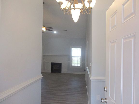 Foyer entry into large living room with high ceilings!