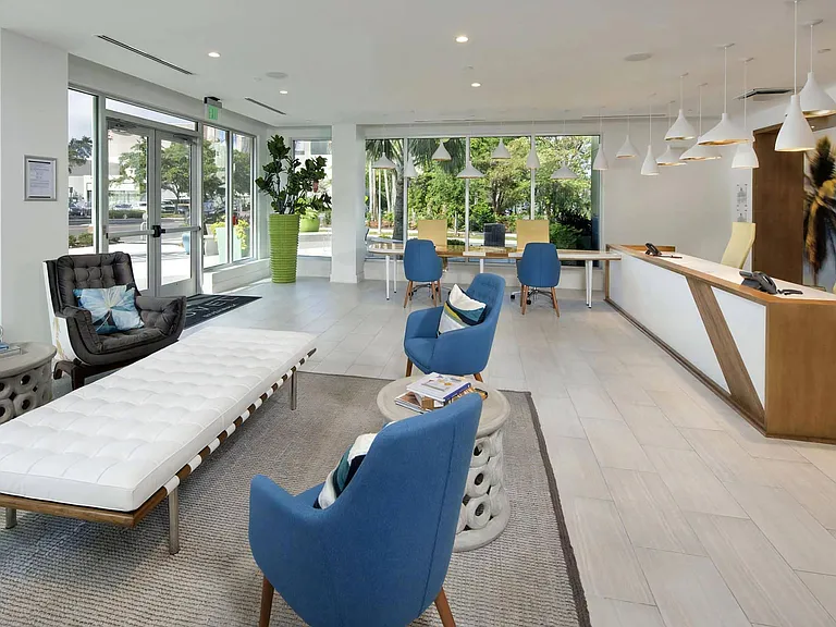 Welcoming Office with Contemporary Furniture and Large Windows Overlooking Greenery