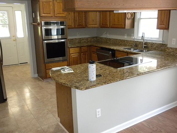 Kitchen View # 1 - Long view with Back Door, Pantry in background. Powder Room across from Pantry.