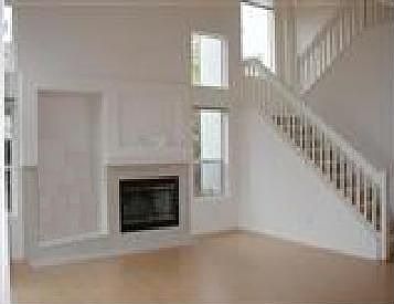 Dramatic Living Room with media niche, fireplace and many windows for a light 
