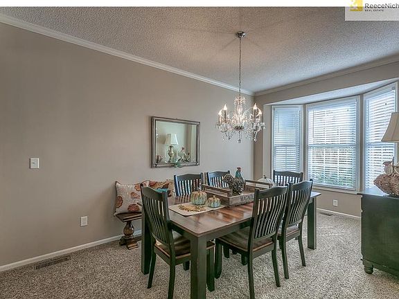 Formal dining room with bay window and lots of natural light.  All window shades stay with the home.