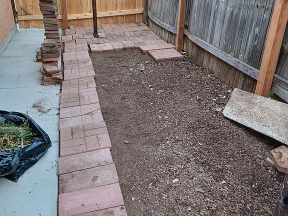 Area on side of garage, to store trash bins, and plant a garden or whatever