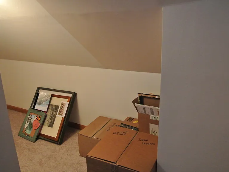 At the top of stairs to the left, there is a crawl space to store things.